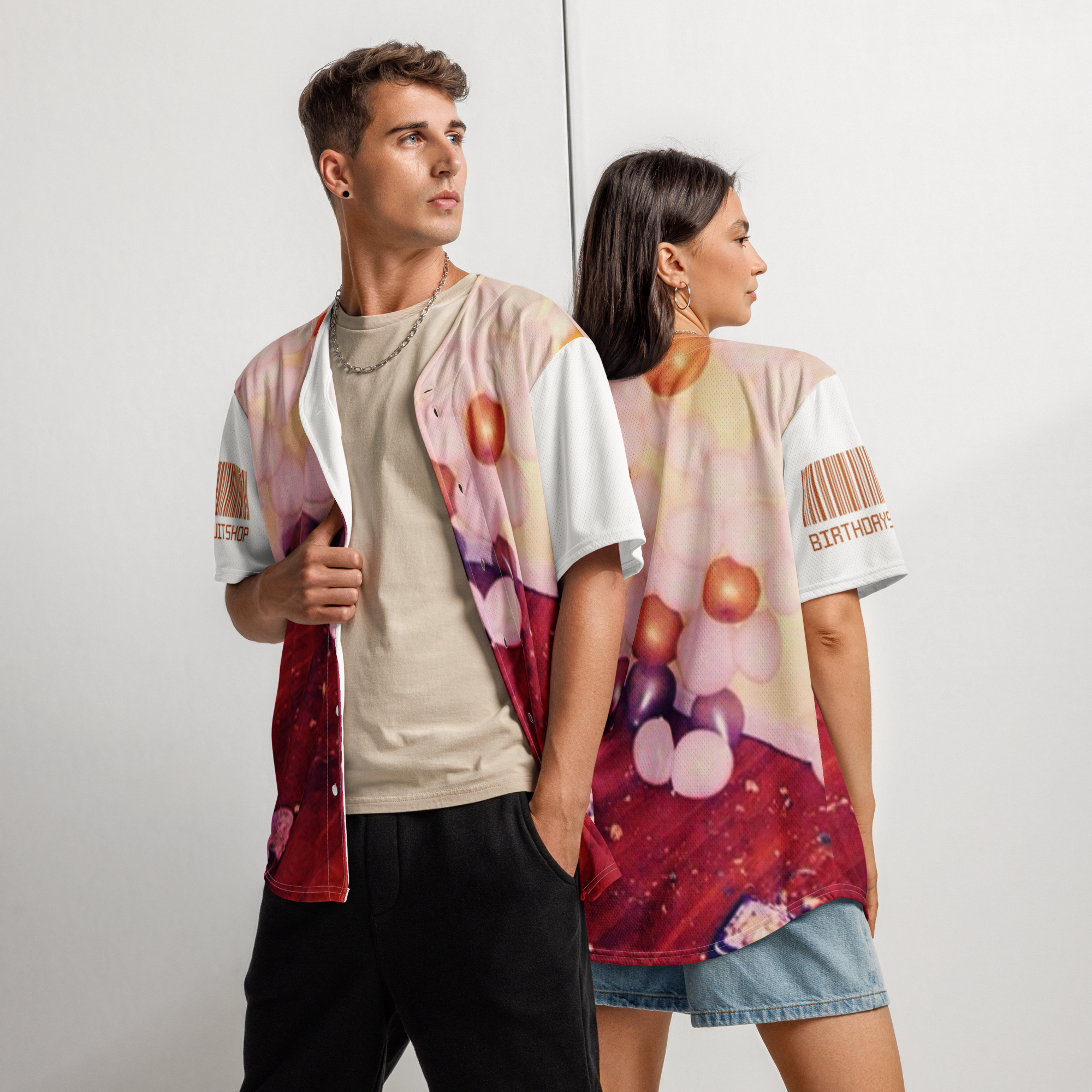 Two people wearing colorful graphic t-shirts against a plain background