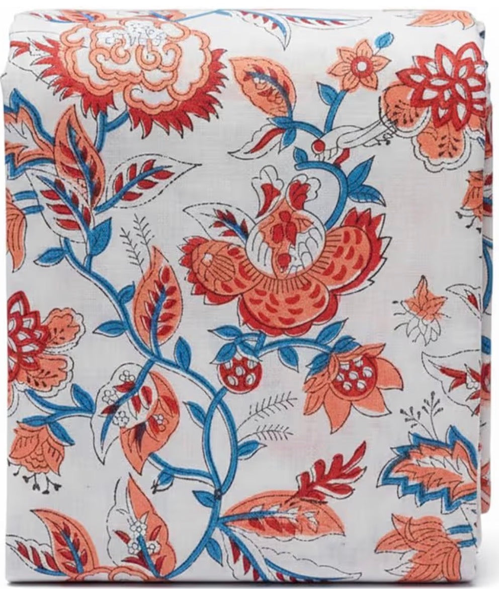 Floral patterned fabric with red and blue flowers on a white background