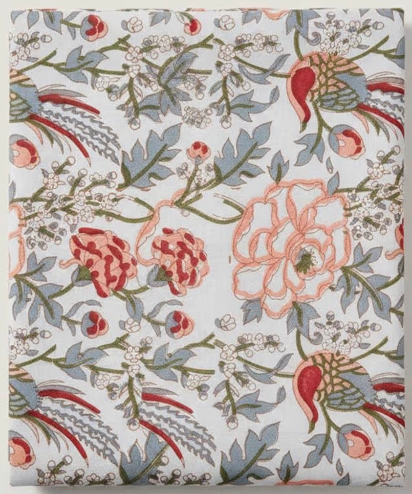 Floral patterned fabric with pink and red flowers on a light background