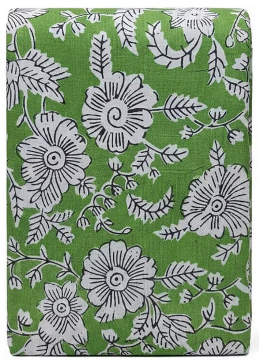 Floral patterned fabric with white flowers on a green background