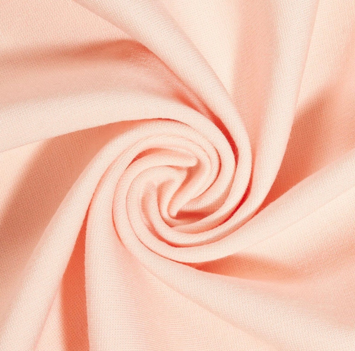 Close-up of pink fabric with a swirl pattern
