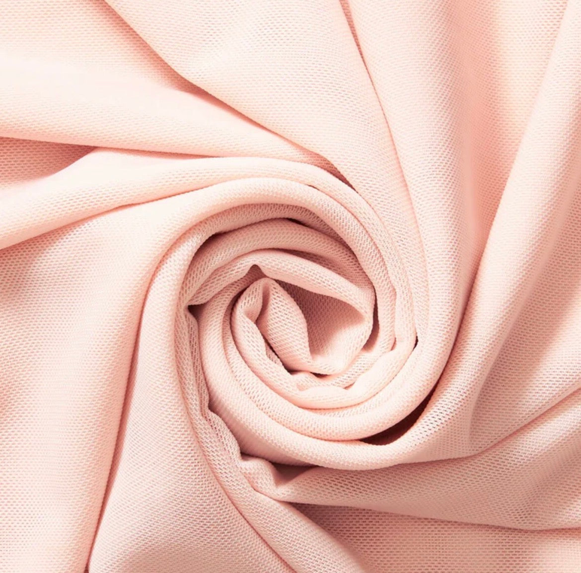 Close-up of pink fabric with a swirl pattern