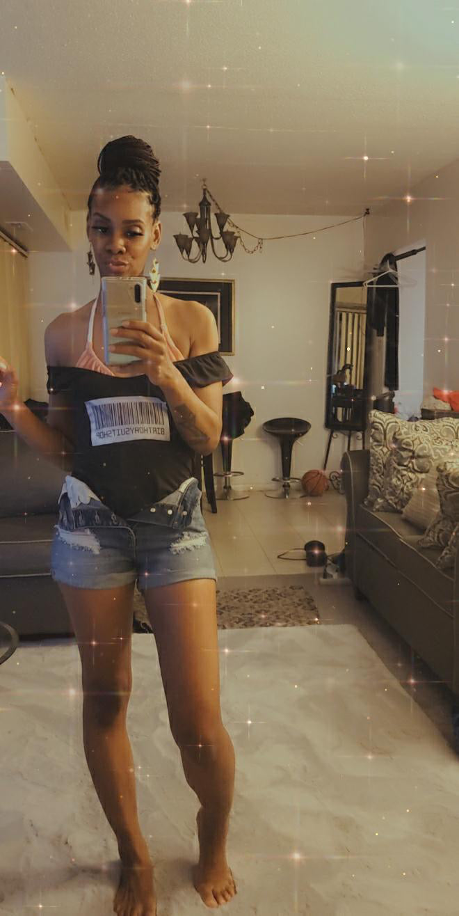Person taking a mirror selfie in a living room.
