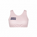 Pink sports bra with a barcode label on a white background