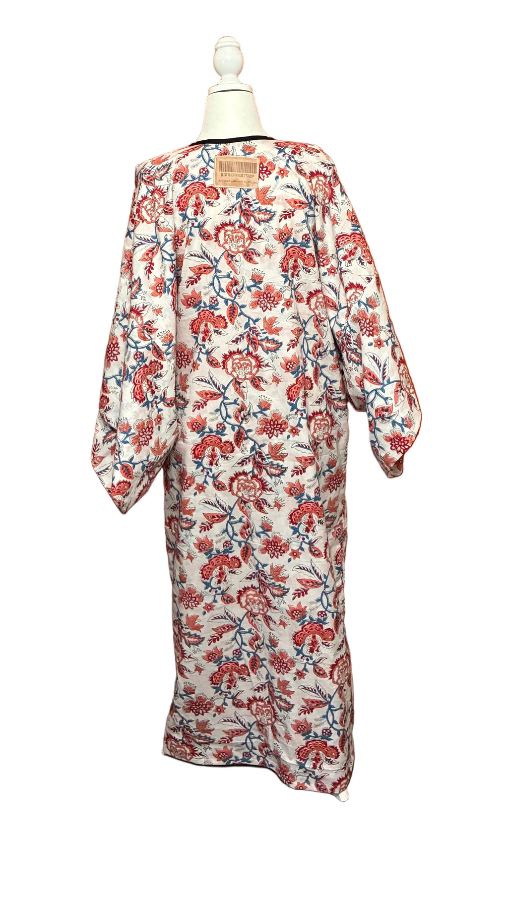 Floral kimono robe on a mannequin against an orange curtain