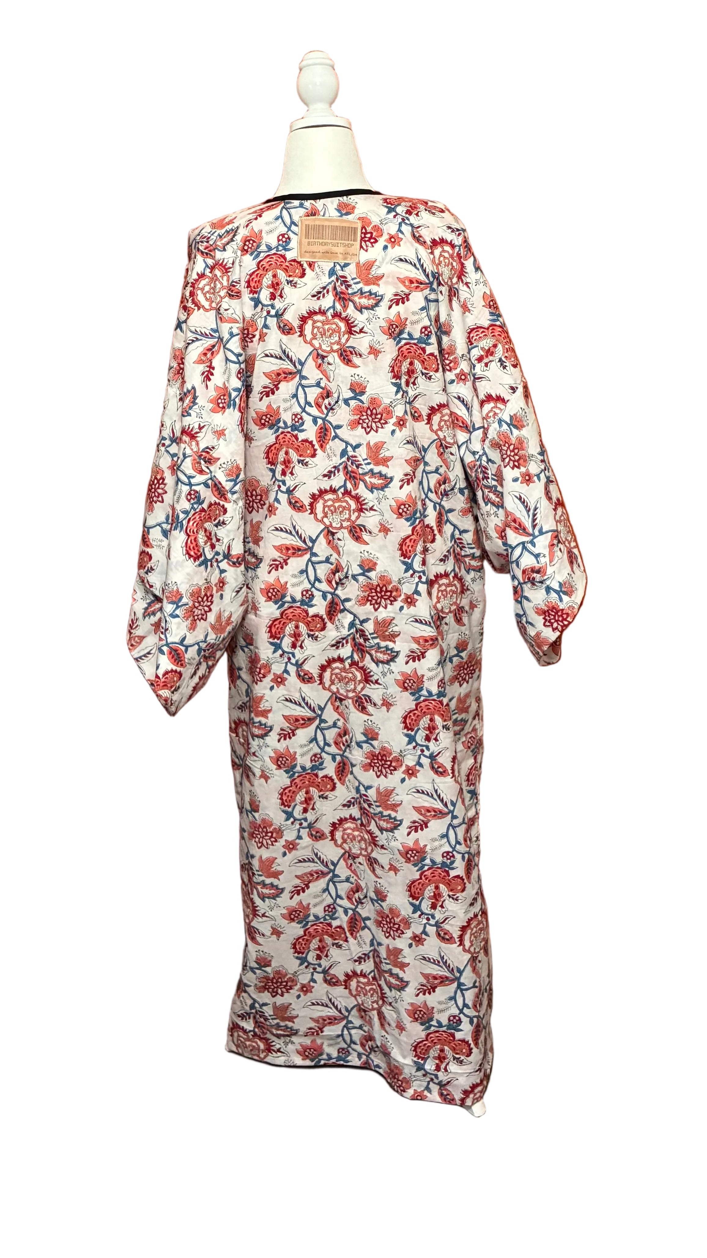 Floral kimono robe on a mannequin against an orange curtain