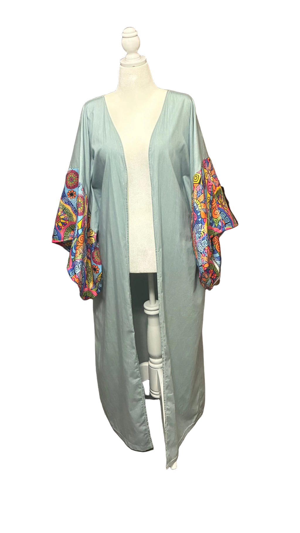 Light blue kimono-style jacket with colorful floral patterns on a mannequin against a white background