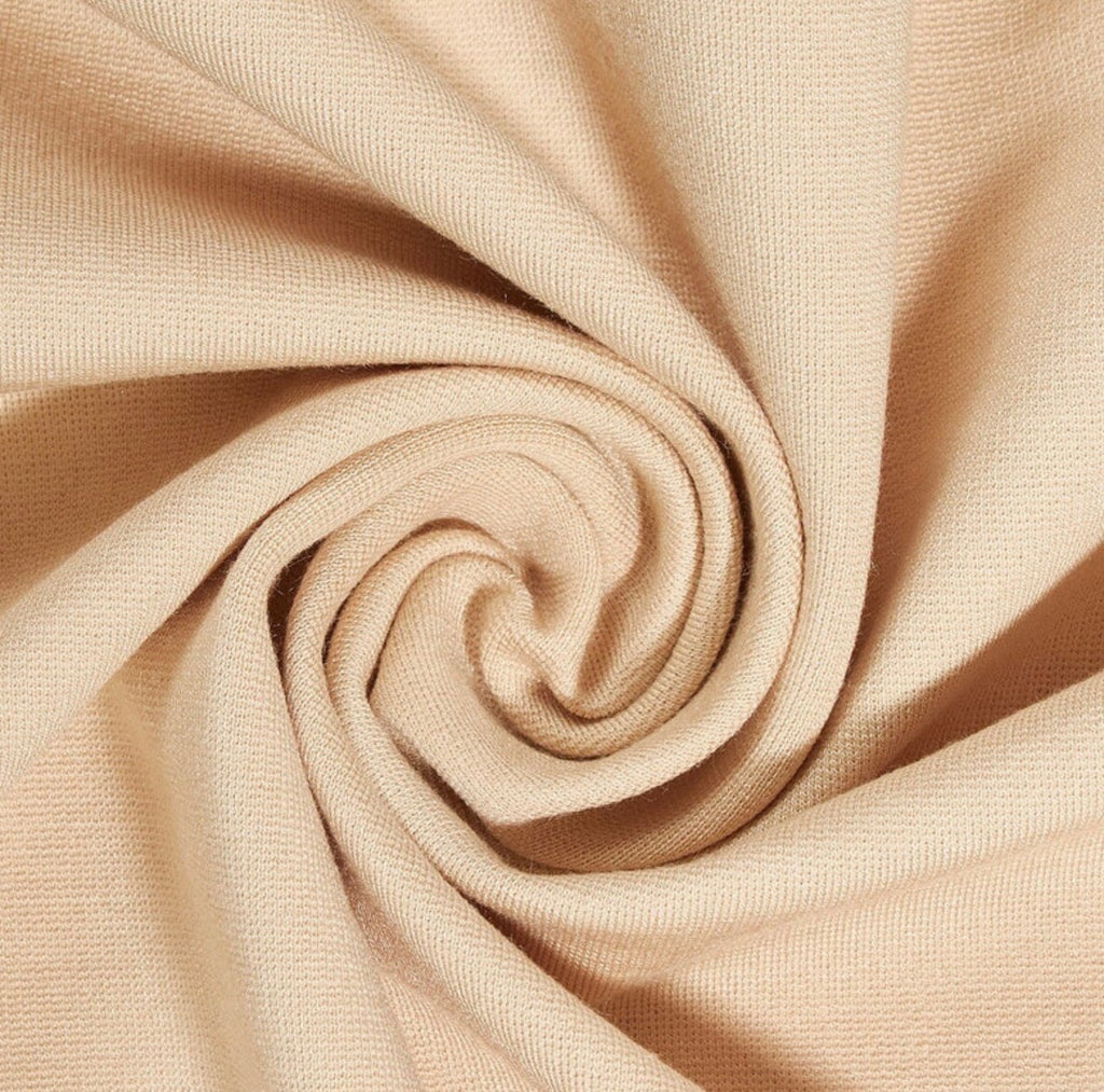 Close-up of beige fabric with a swirl pattern