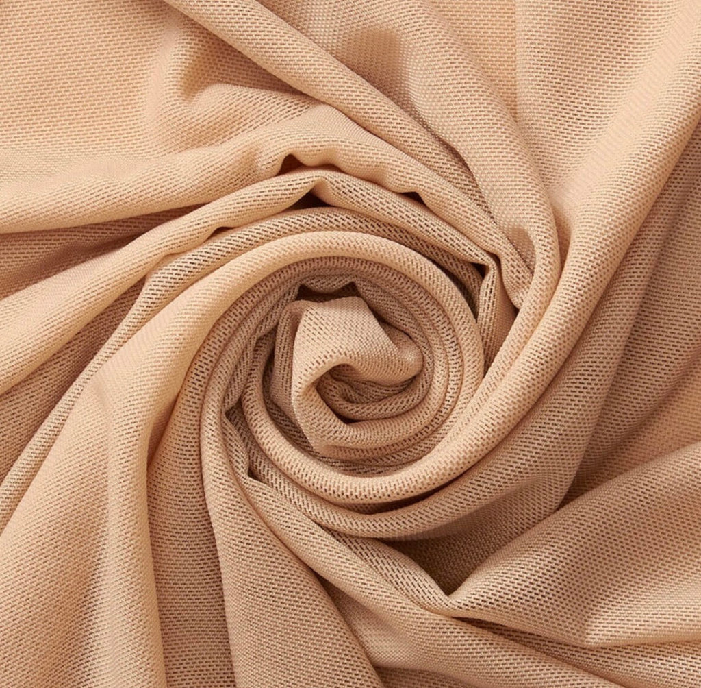 Close-up of beige fabric with a spiral pattern