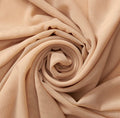 Close-up of beige fabric with a spiral pattern
