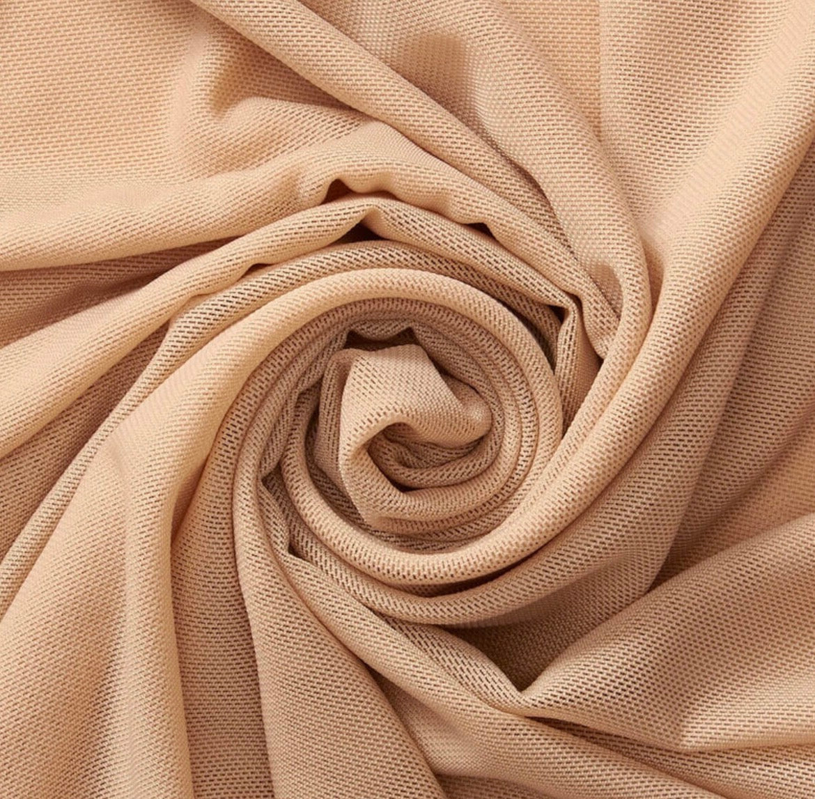 Close-up of beige fabric with a spiral pattern