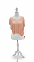 Mannequin wearing a blush -colored top on a white background