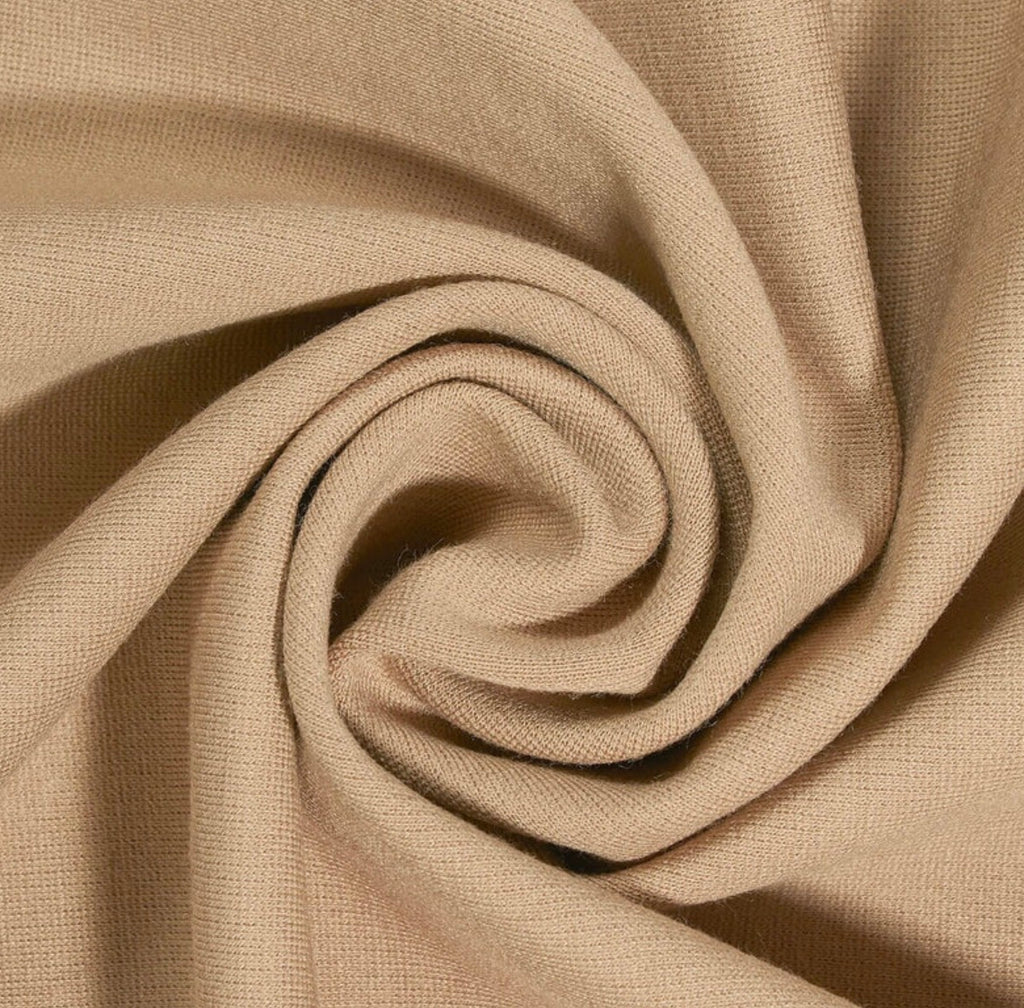 Close-up of beige fabric with a spiral pattern