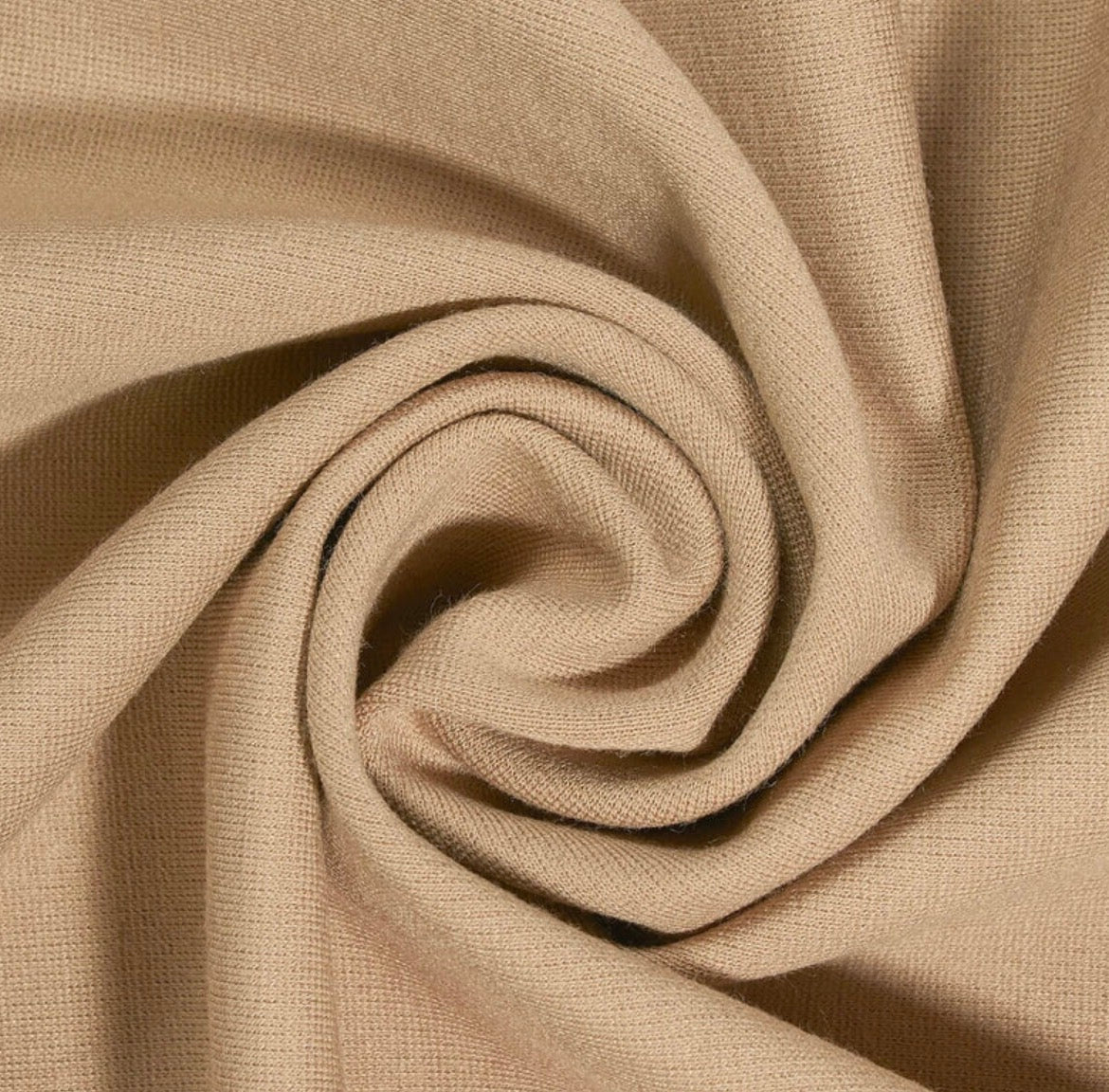 Close-up of beige fabric with a spiral pattern